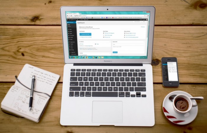 Open laptop on wooden desk.