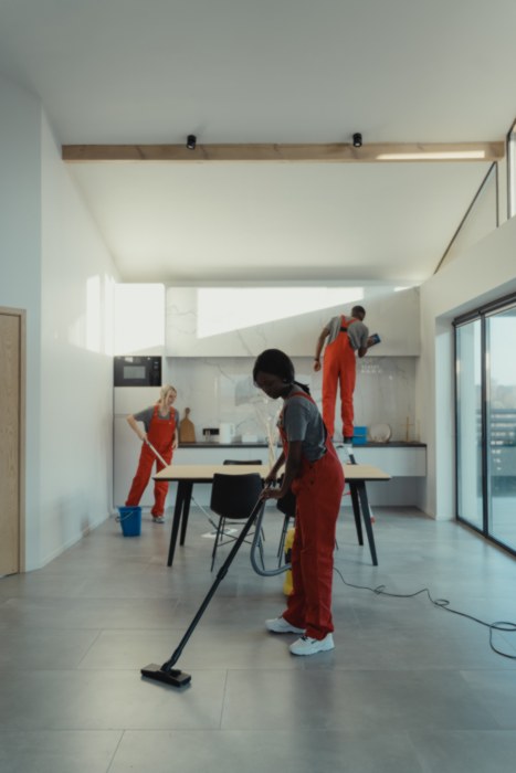 Team of cleaners cleaning floor