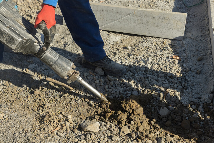 Concrete breaker being used on paving