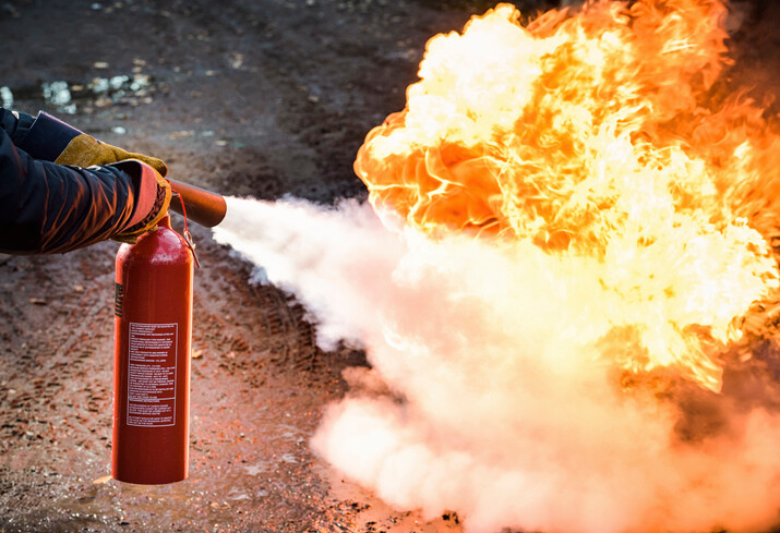 fire extinguisher in use to put out fire