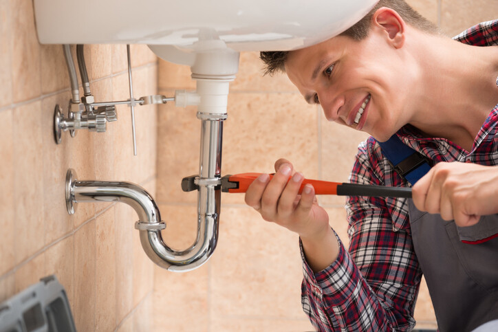 Man fixing sink witch wrench