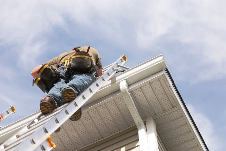 Man on roof ladder