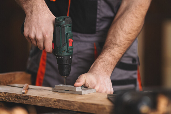 Man using small drill on tiles