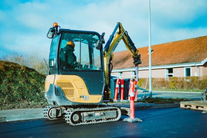 yellow mini digger stock photo