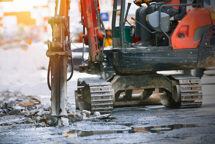 Mini digger with breaker attachment