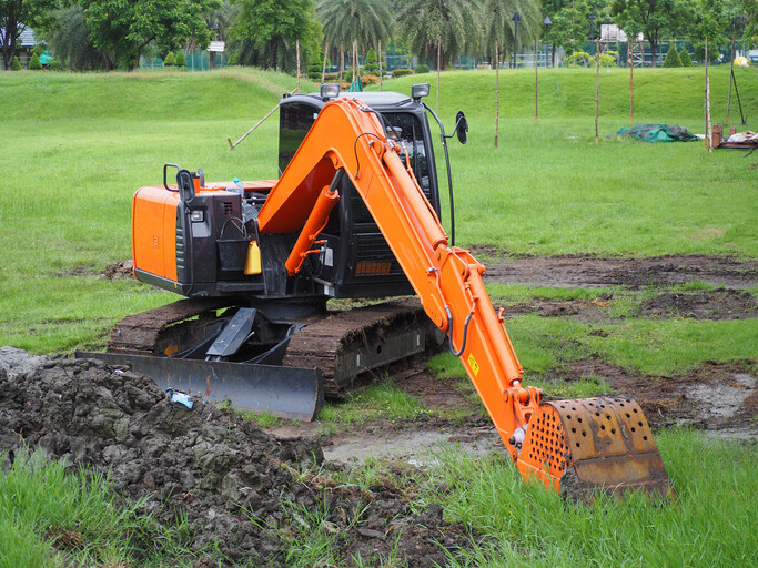 Mini digger working in field