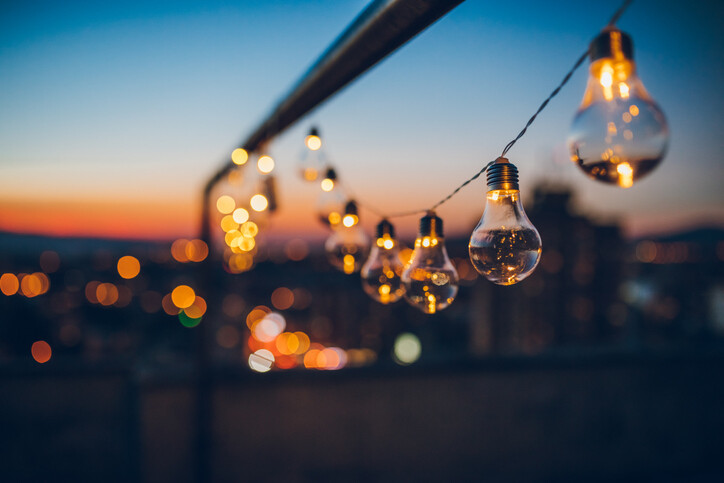 String of festoon lights faintly glowing at dusk