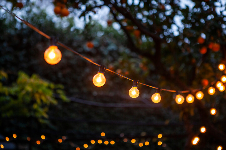 String of festoon lights on summer evening