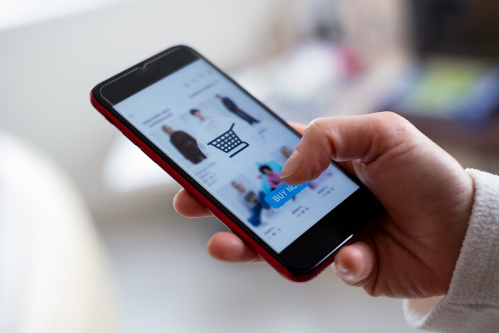 thub-poised-over-buy-button-on-mobile-phone-app