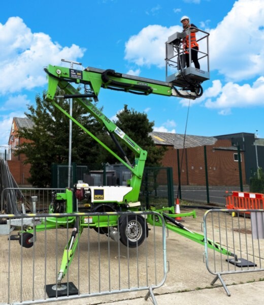 Trainees operating green spider lift.