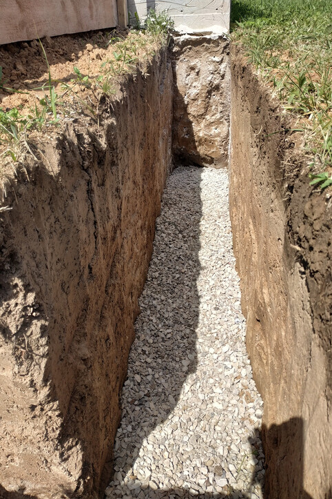 trench for foundations linedwith gravel