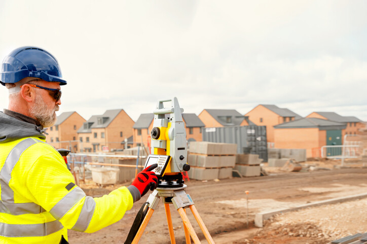 worker adjusting laser level settings