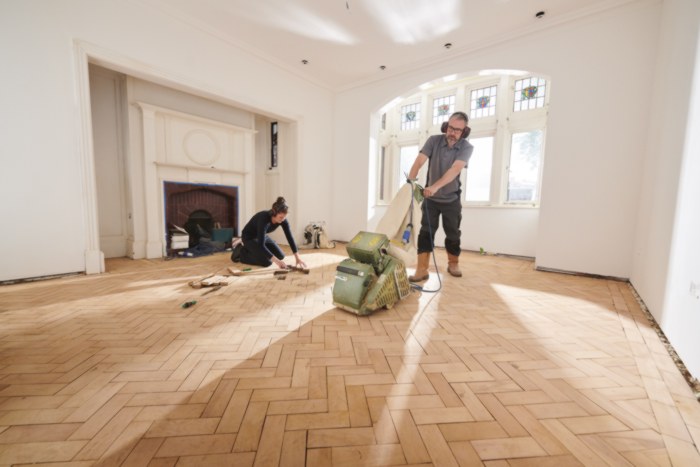 workers restoring wooden floorboards